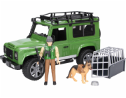 Land Rover Defender s figurkou lesníka a psa